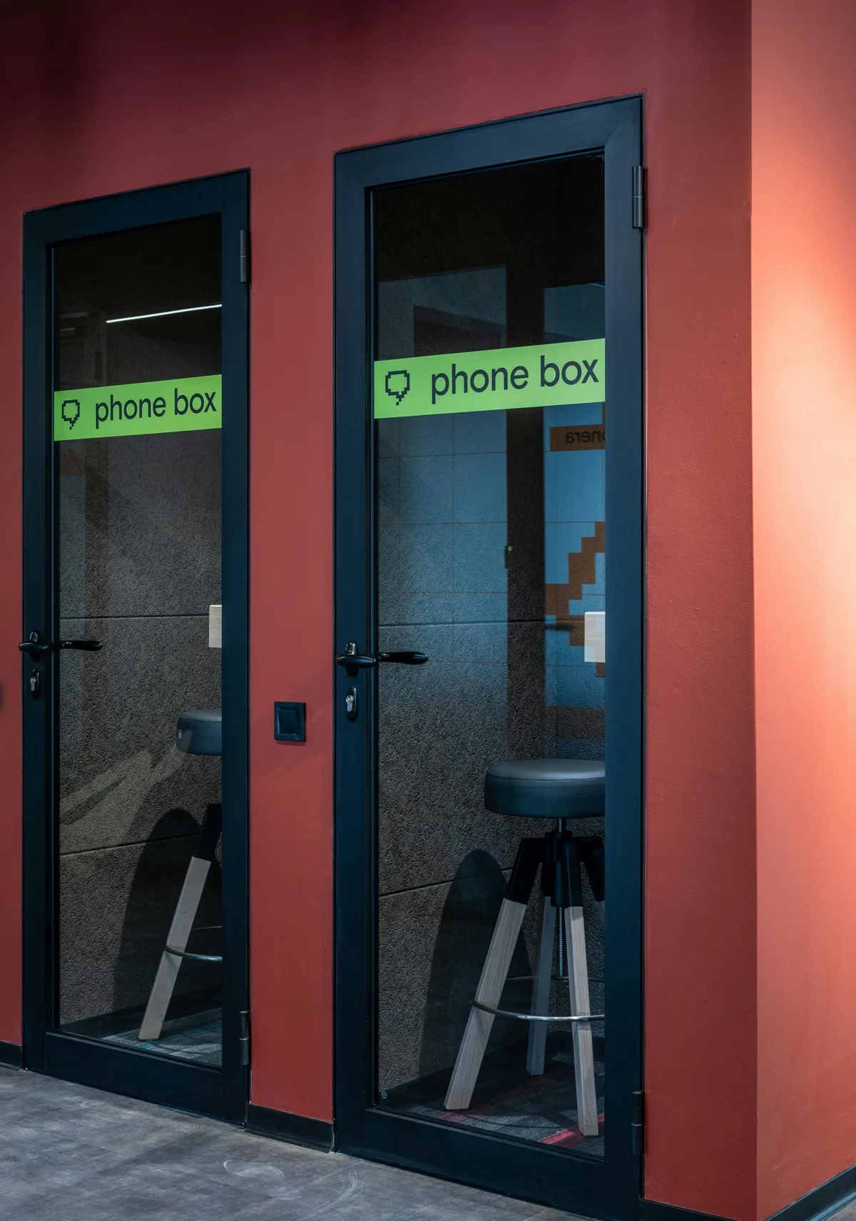 Basecamp Coworking main workspace with members working at standing desks and collaborative tables